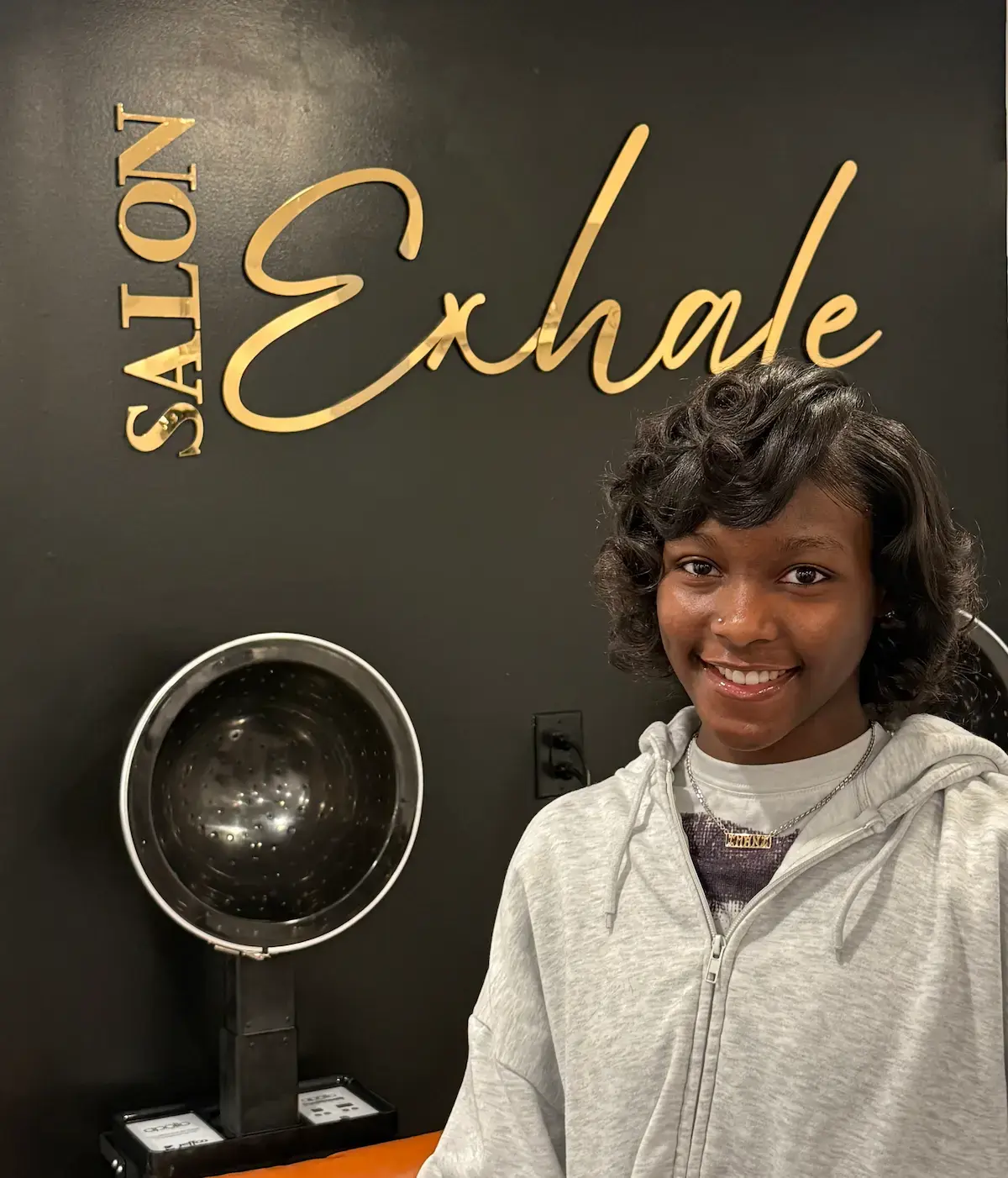 Client with a fresh, precision haircut at Salon Exhale featuring smooth, even-length hair